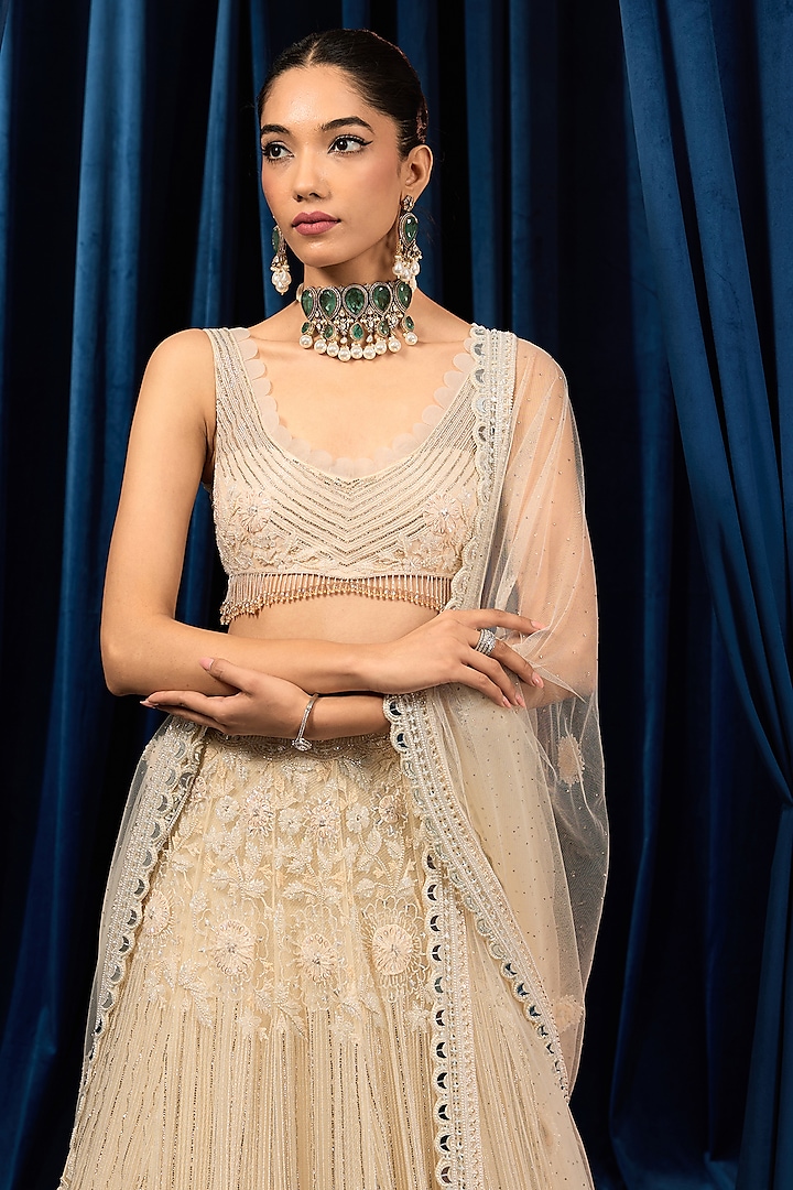 Ivory Net Floral Embroidered Bridal Lehenga Set by AWIGNA BY VARSHA & RITTU at Pernia's Pop Up Shop