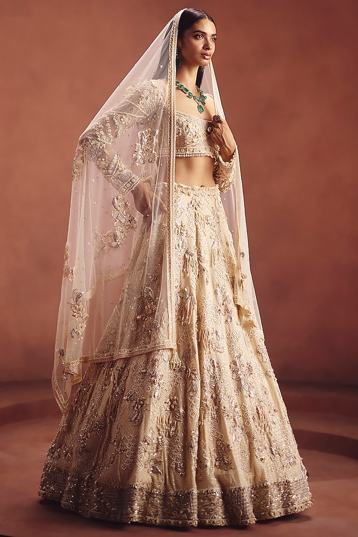 Ivory Net Embroidered Bridal Lehenga Set by AWIGNA BY VARSHA & RITTU at Pernia's Pop Up Shop