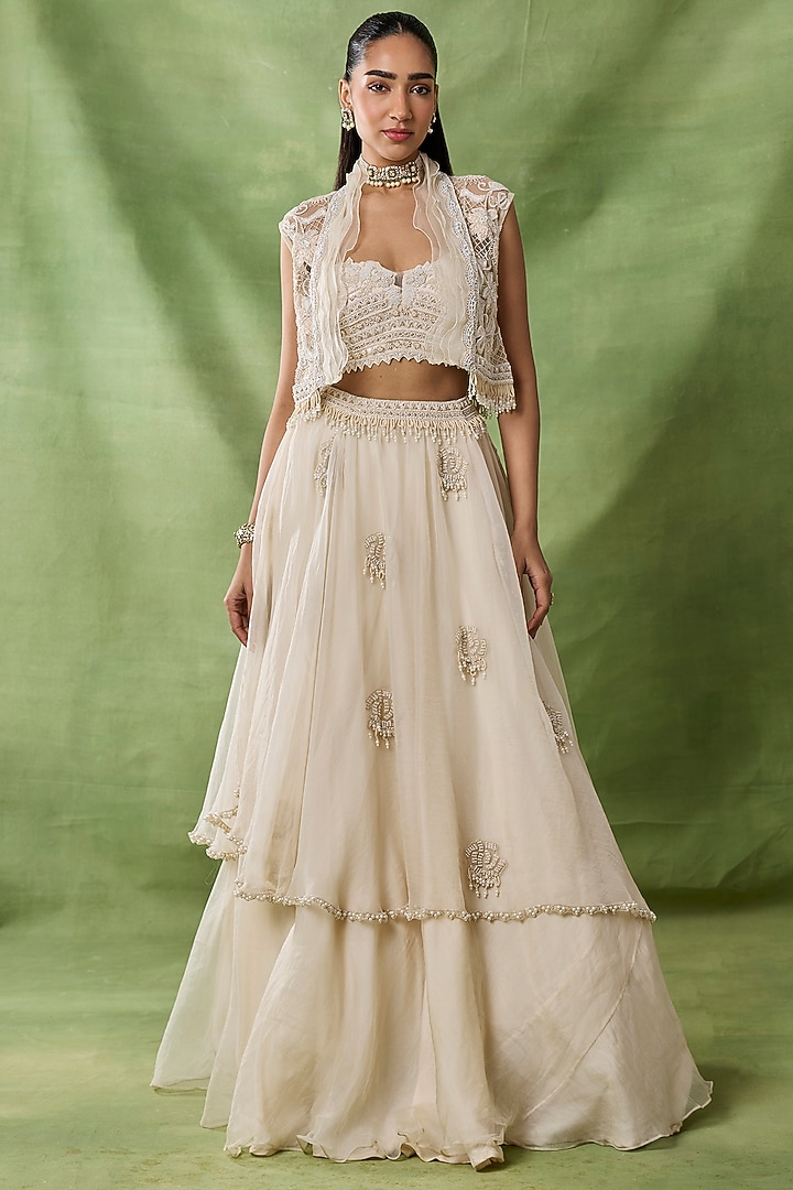 Ivory Organza Net Ruffled Layered Skirt Set by AWIGNA BY VARSHA & RITTU at Pernia's Pop Up Shop