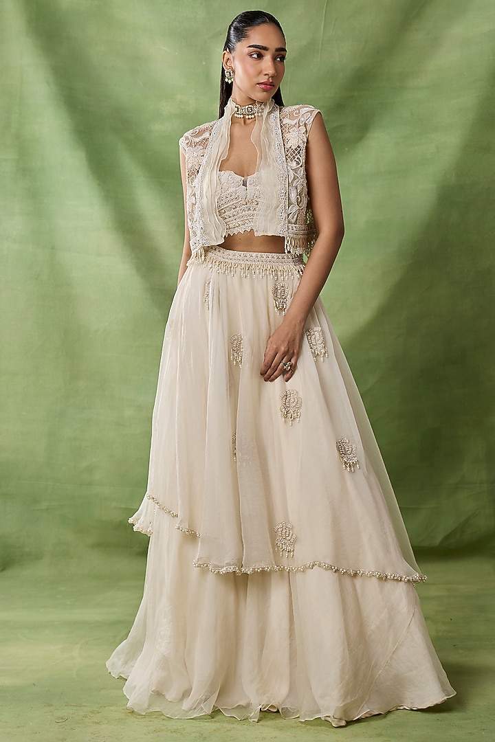 Ivory Organza Net Ruffled Layered Skirt Set by AWIGNA BY VARSHA & RITTU at Pernia's Pop Up Shop