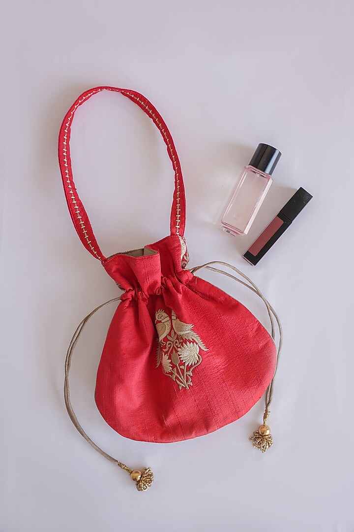 Red Raw Silk Hand Block Printed & Tassels Embroidered Potli Bag by ADYA Jaipur at Pernia's Pop Up Shop