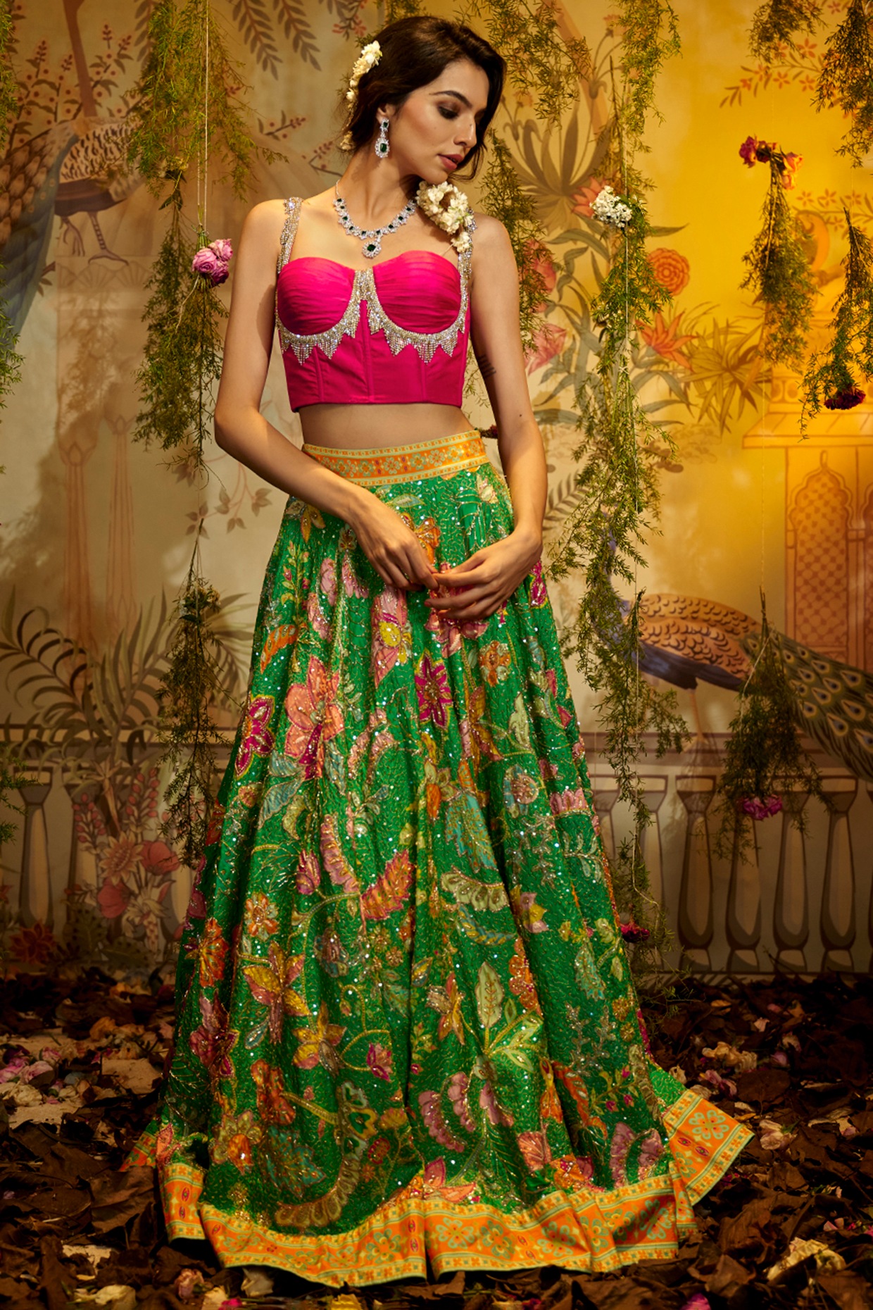 Photo of Bride wearing a pastel pink lehenga with a yellow dupatta and  emerald jewellery.