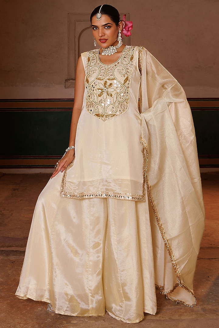 Ivory & Gold Tissue Party Wear Sharara Set by Bannhi by Priyanka Rathore at Pernia's Pop Up Shop