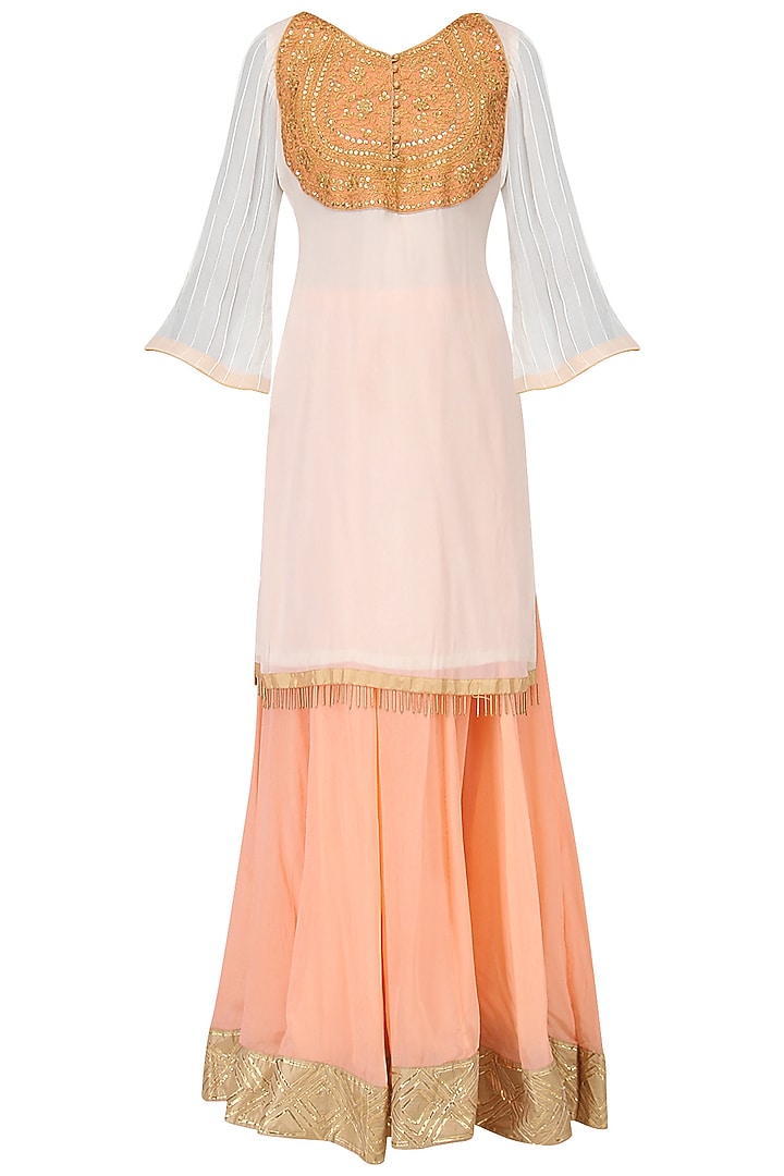 White embroidered kurta with peach lehenga set available only at Pernia's Pop Up Shop.