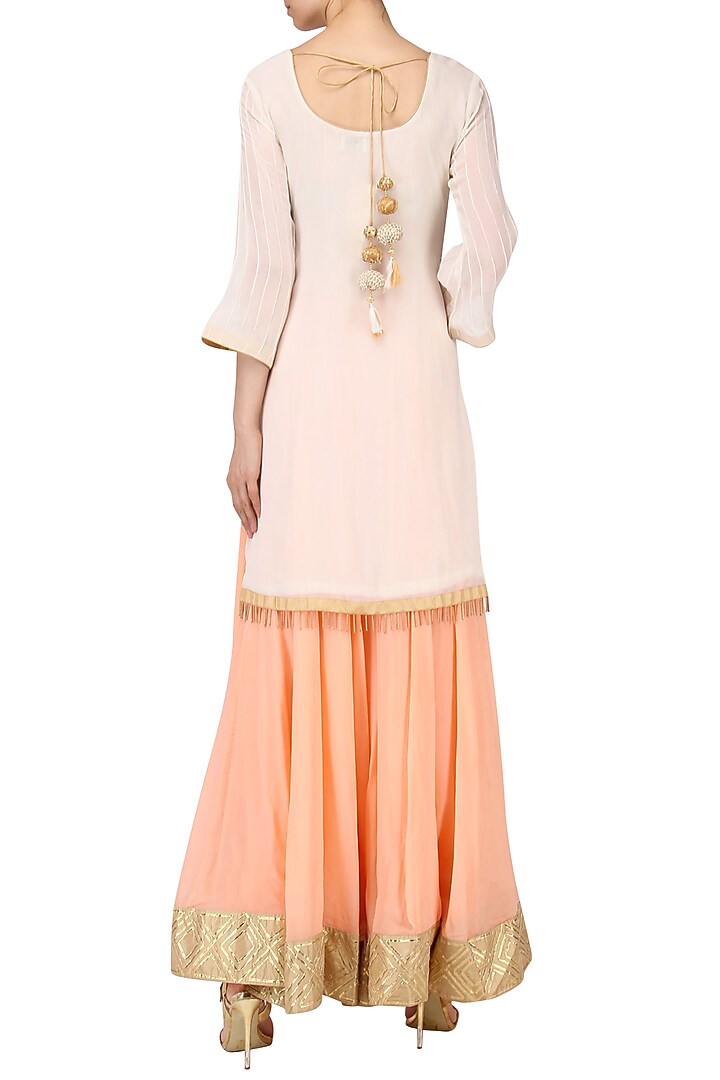 White embroidered kurta with peach lehenga set available only at Pernia's Pop Up Shop.