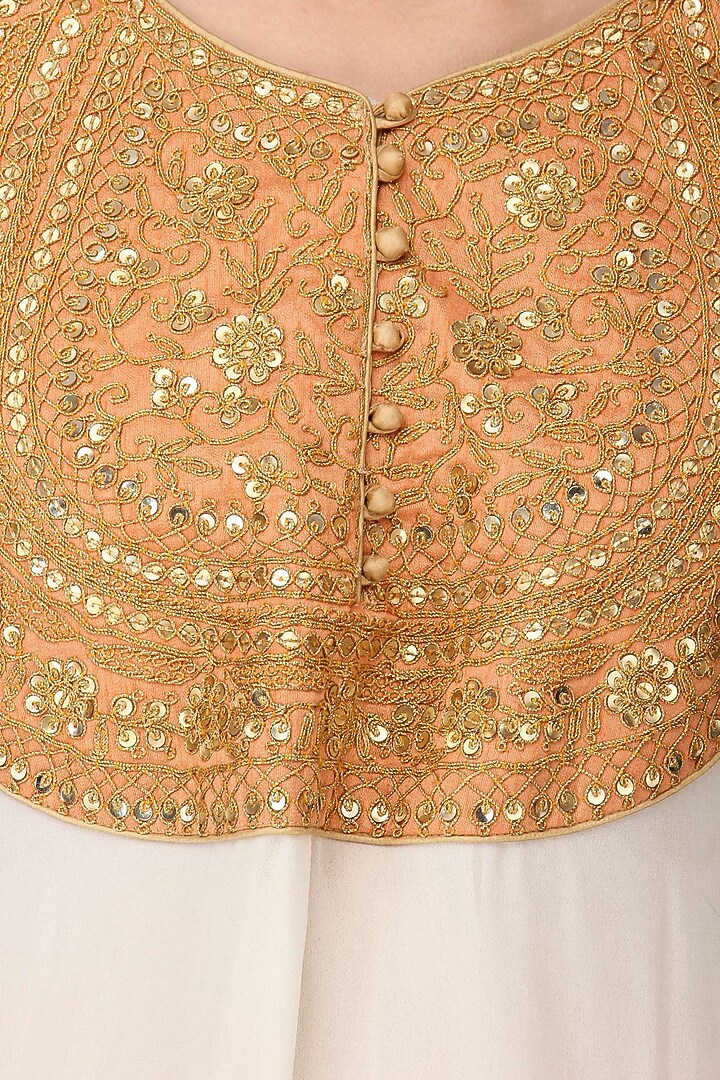 White embroidered kurta with peach lehenga set available only at Pernia's Pop Up Shop.