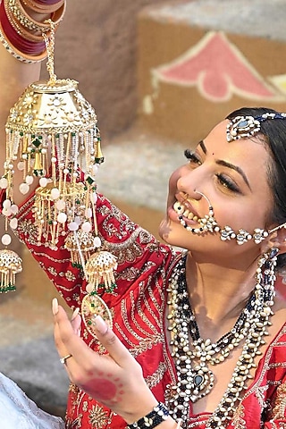 Gold Finish Kundan Polki & Pearl Kaleeras (Set of 2) by Beabhika