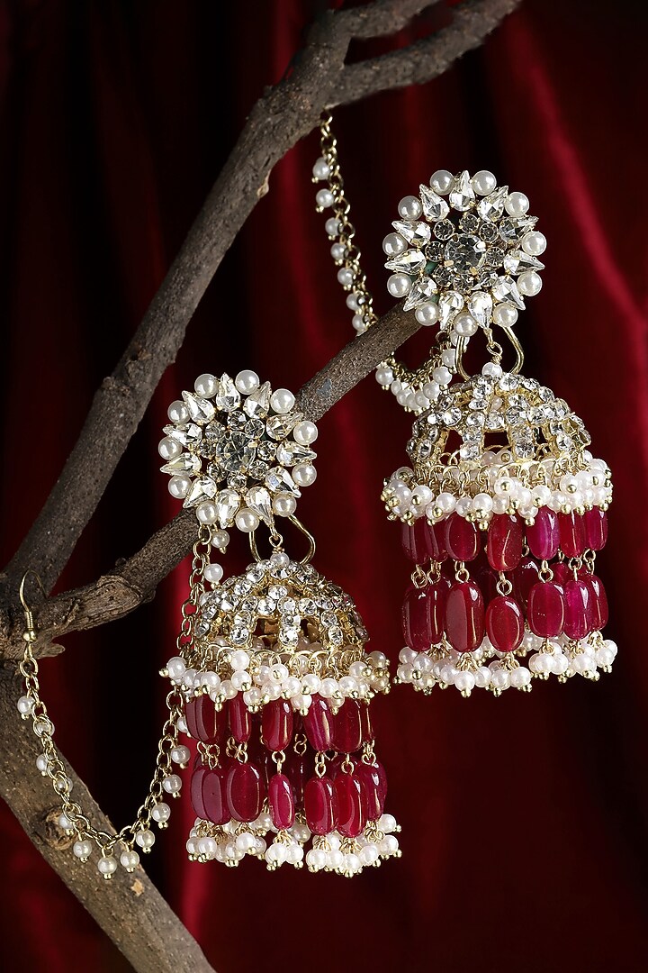 Gold Finish Crystal & Semi-Precious Red Stone Jhumka Earrings by Bijoux By Priya Chandna at Pernia's Pop Up Shop
