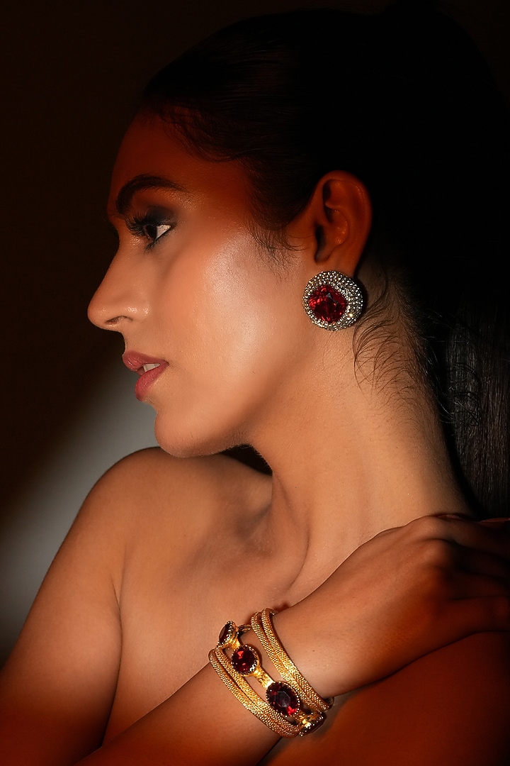 Gold Finish Metal Chain & Red Crystal Stone Sculpted Bracelet by Bijoux By Priya Chandna at Pernia's Pop Up Shop