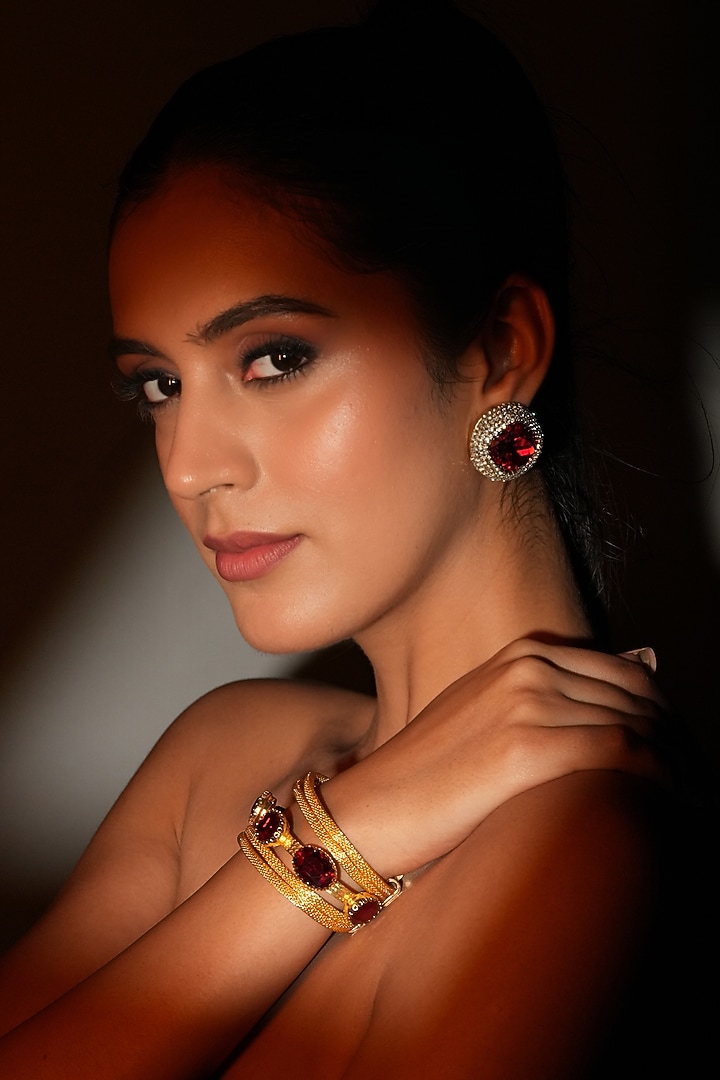 Gold Finish Deep Red Crystal Stone Stud Earrings by Bijoux By Priya Chandna at Pernia's Pop Up Shop