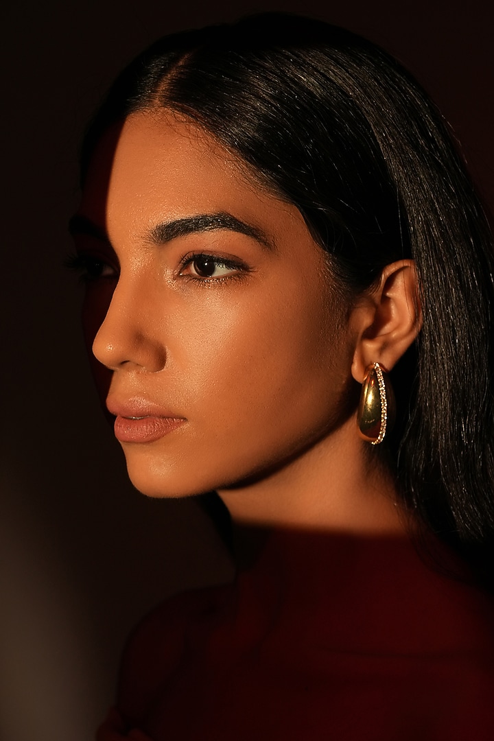 Gold Finish Crystal Bean-Shaped Stud Earrings by Bijoux By Priya Chandna at Pernia's Pop Up Shop