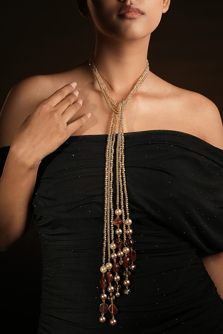 Gold Finish Pearl Drop & Coffee Brown Beaded Lariat Knot Necklace by Bijoux By Priya Chandna at Pernia's Pop Up Shop
