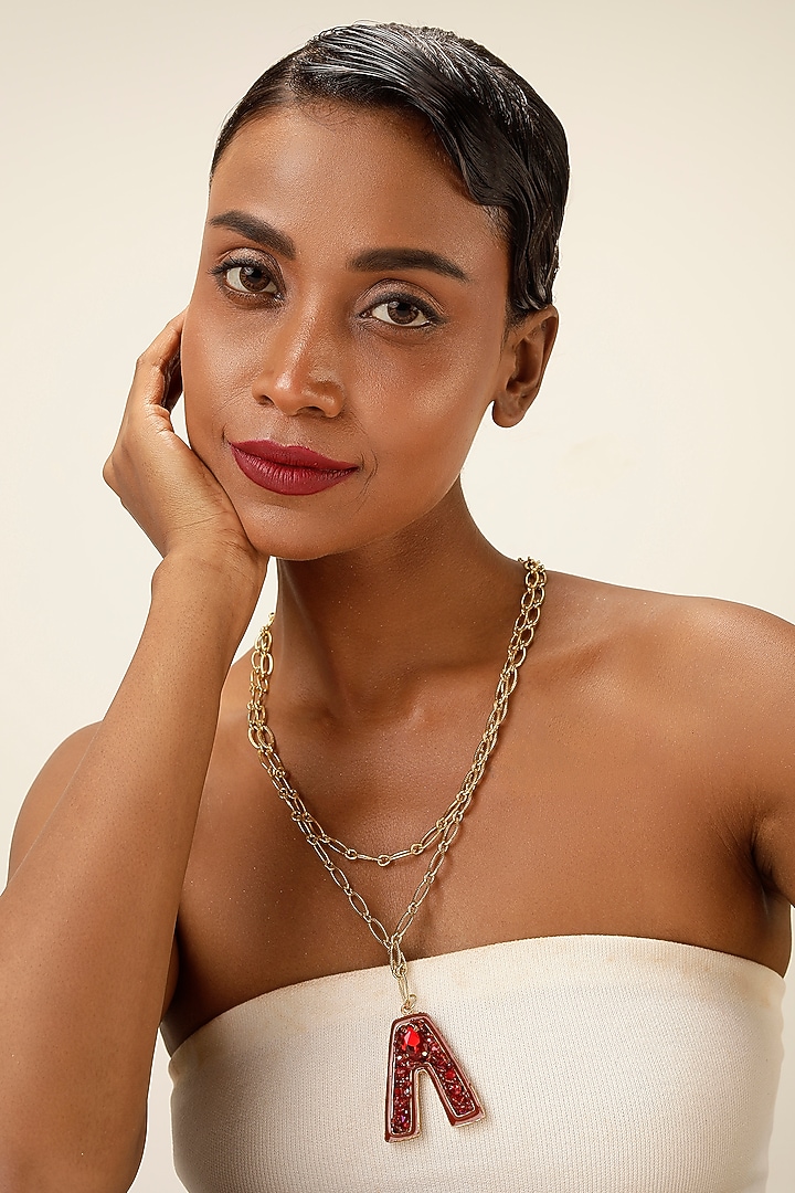 Gold Finish Red Crystal Initial Pendant Necklace by Bijoux By Priya Chandna at Pernia's Pop Up Shop