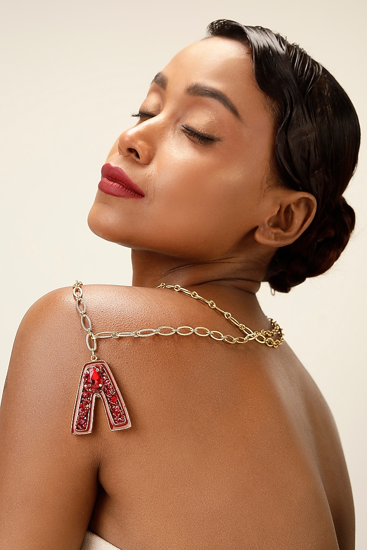 Gold Finish Red Crystal Initial Pendant Necklace by Bijoux By Priya Chandna at Pernia's Pop Up Shop
