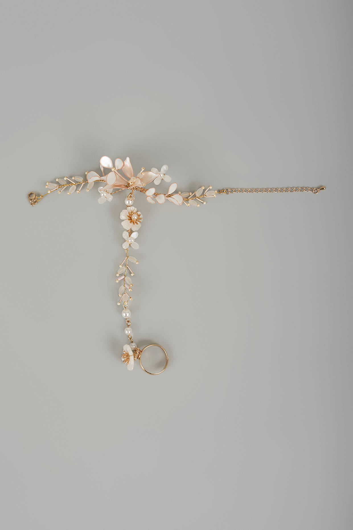 Gold Finish White Enameled Handcrafted Adjustable Floral Hand Harness by THE BEAUTIFUL SECRET at Pernia's Pop Up Shop