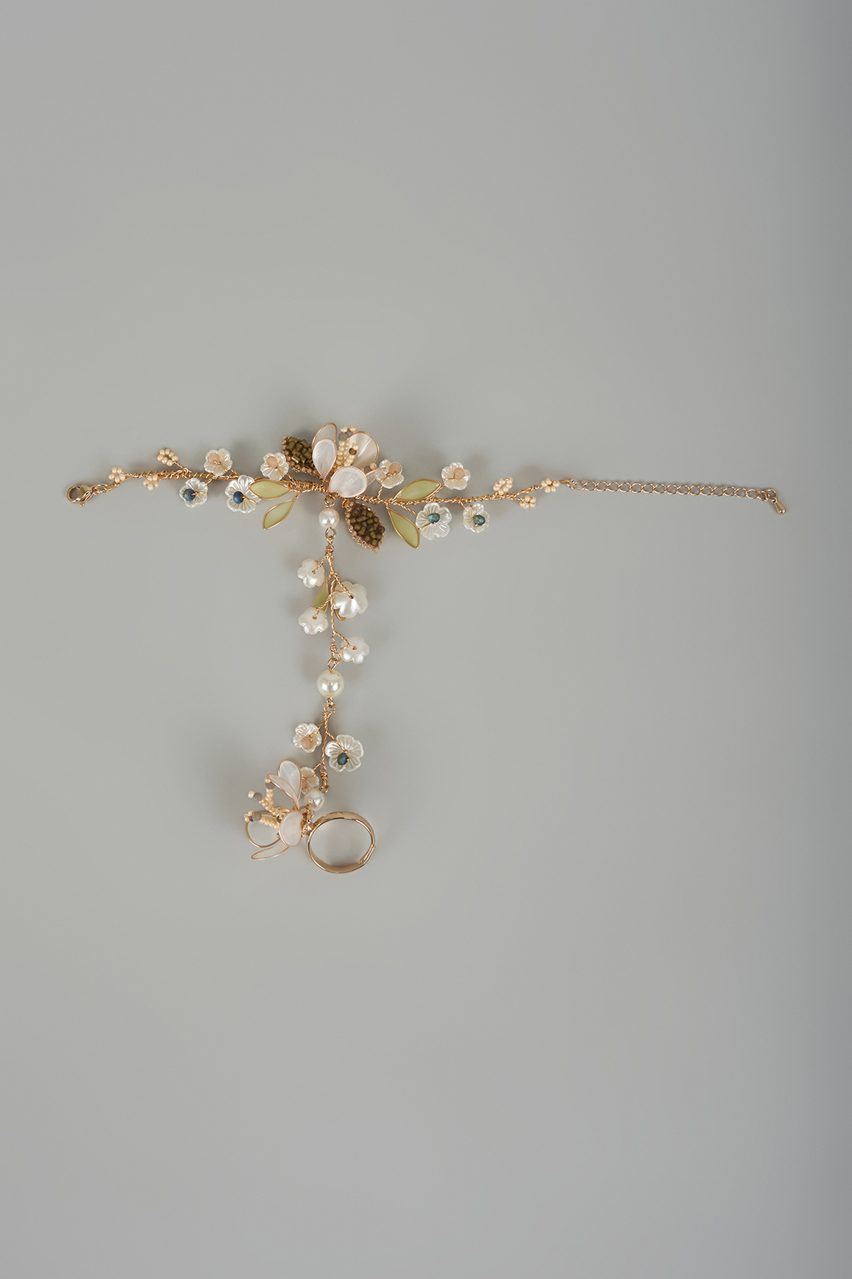 Gold Finish White Enameled Handcrafted Adjustable Floral Hand Harness by THE BEAUTIFUL SECRET at Pernia's Pop Up Shop
