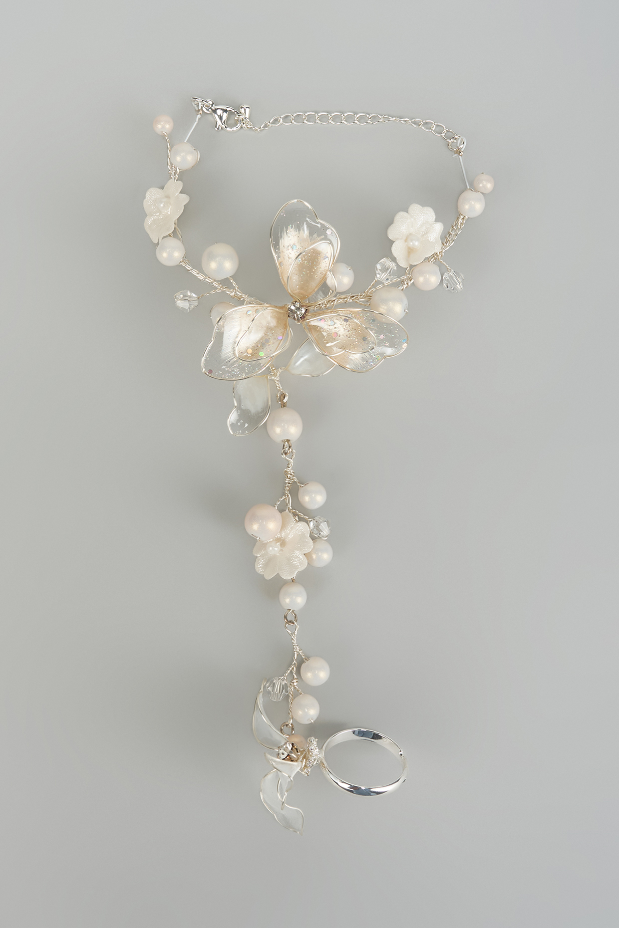 Silver Finish White Stone Adjustable Hathphools (Set Of 2) by THE BEAUTIFUL SECRET at Pernia's Pop Up Shop