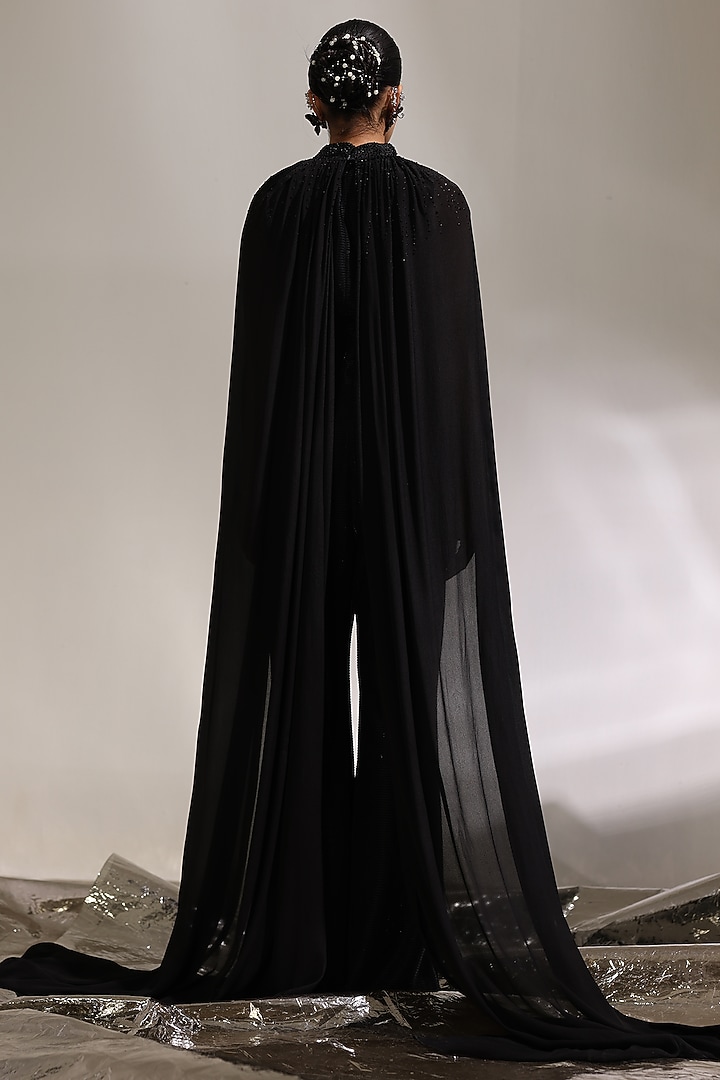 Ebony Black Textured Fabric & Gossamer Chiffon Jumpsuit With Cape by CP by Chandini and Priyanka at Pernia's Pop Up Shop