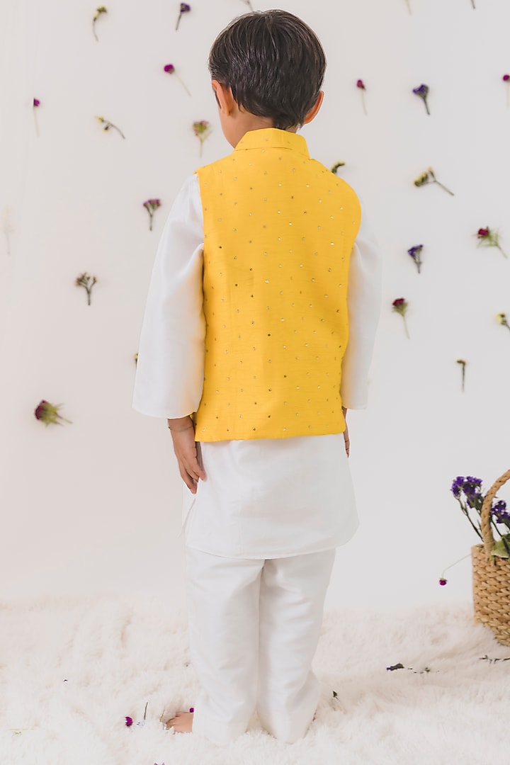 Yellow Cotton Silk Embroidered Bundi Jacket Set For Boys
by Chotibuti at Pernia's Pop Up Shop