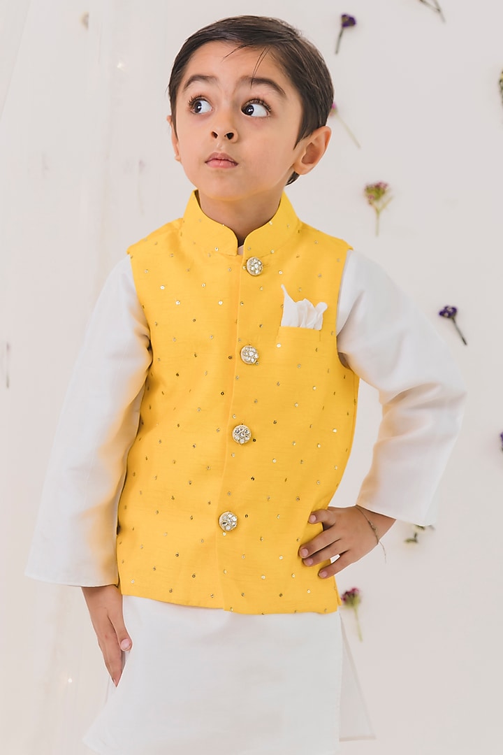 Yellow Cotton Silk Embroidered Bundi Jacket Set For Boys
by Chotibuti at Pernia's Pop Up Shop