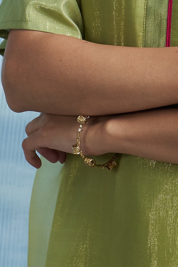 Gold Finish Aura Bangle by Charkhee Accessories at Pernia's Pop Up Shop