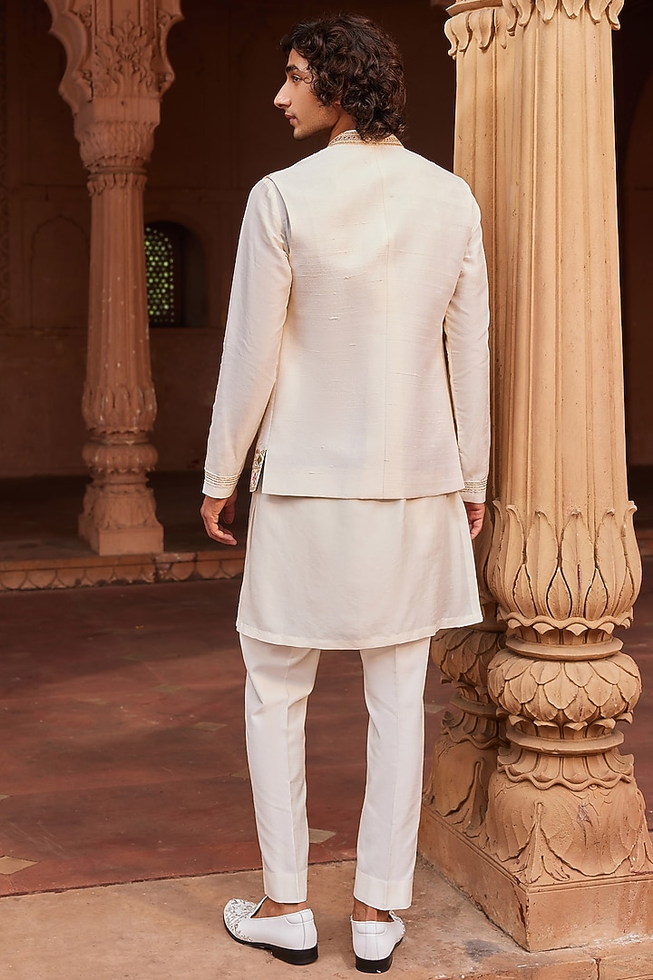 Ivory Raw Silk Cutdana & Mirror Work Nehru Jacket Set by Contrast By Parth at Pernia's Pop Up Shop