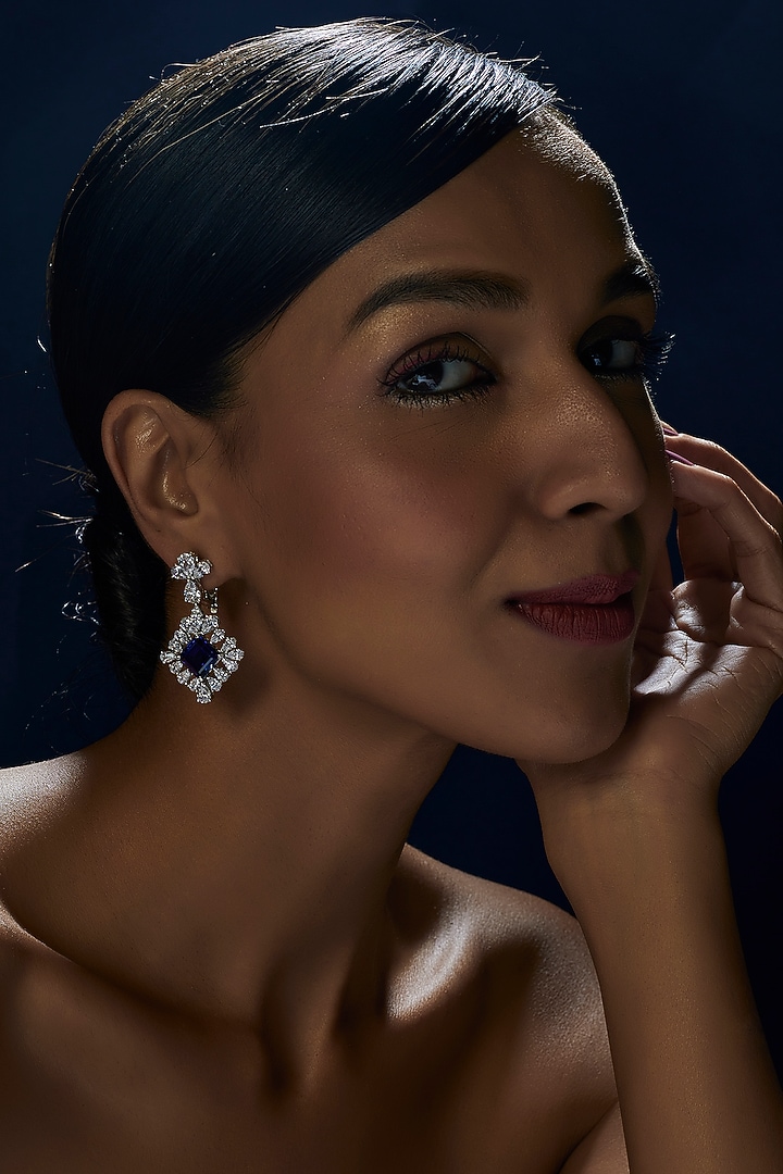 White Finish Princess Cut Blue Stone Dangler Earrings In Sterling Silver by Diosa Paris Jewellery at Pernia's Pop Up Shop