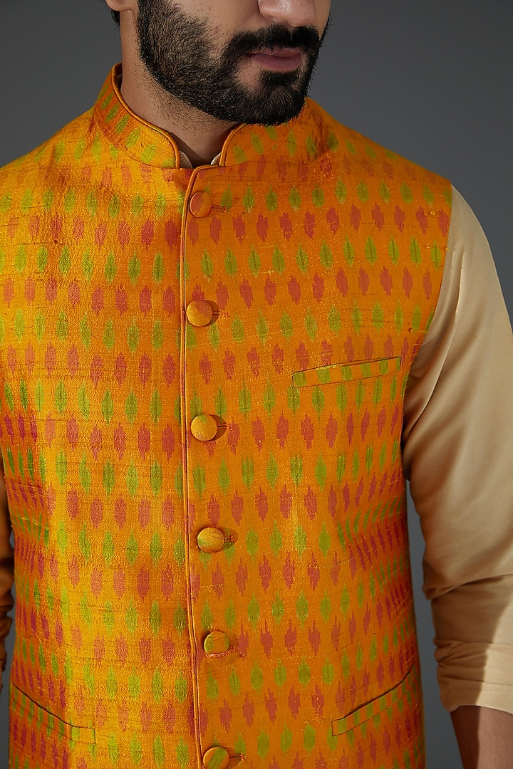 Orange Raw Silk Ikat Printed Bundi Jacket by Darshika at Pernia's Pop Up Shop
