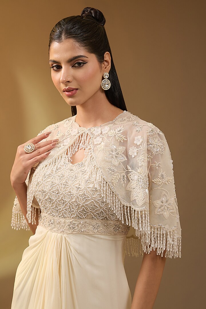 Ivory Net & Georgette Embroidered Stitched Draped Engagement Gown With Cape by Devika Bhayana at Pernia's Pop Up Shop