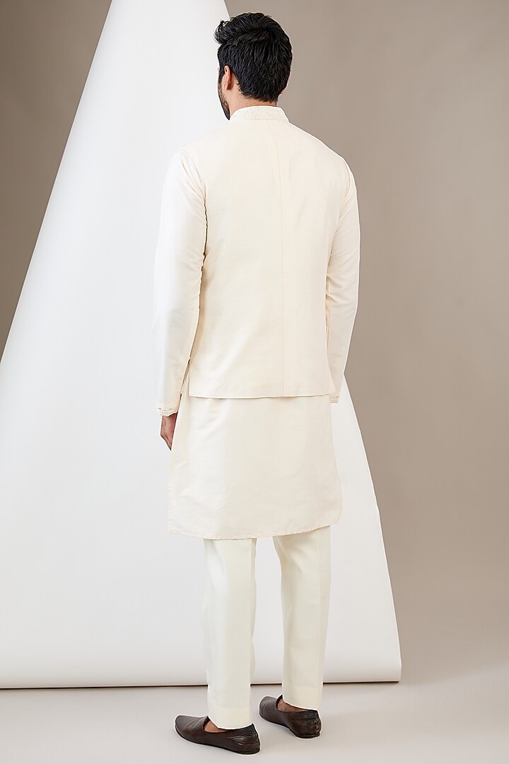 Ivory Raw Silk Resham & Cutdana Embroidered Bundi Jacket Set by Dev Kumar at Pernia's Pop Up Shop