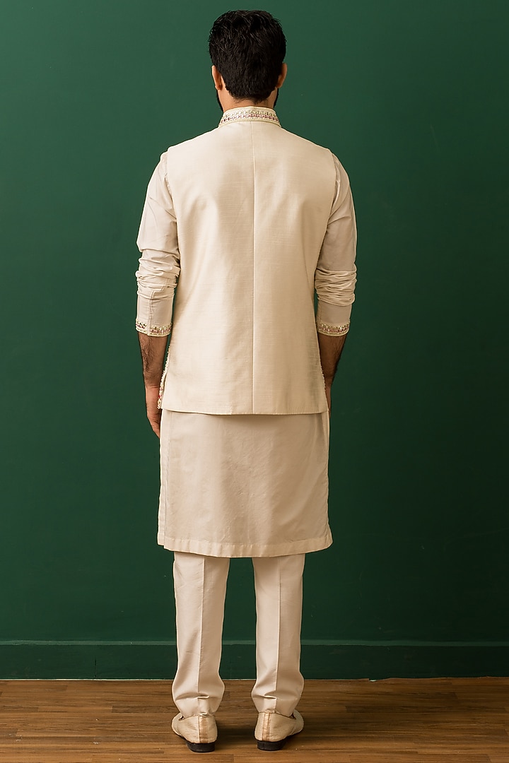 Ivory Raw Silk Resham Embroidered Nehru Jacket Set by Dev Kumar at Pernia's Pop Up Shop