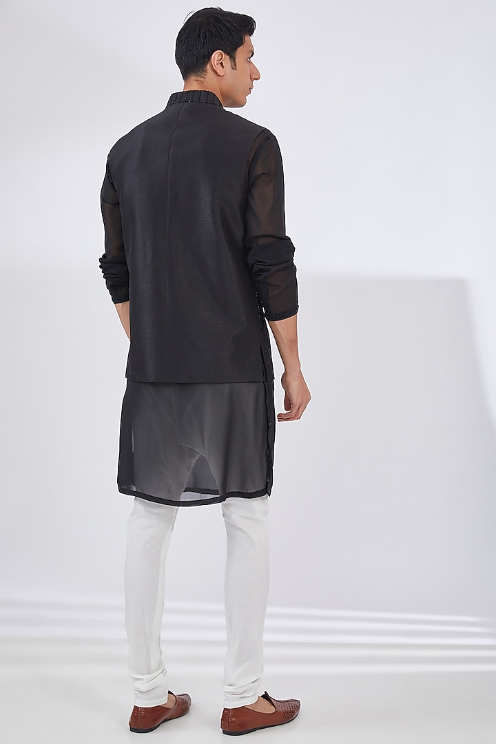 Black Raw Silk Embroidered Bundi Jacket Set by Dev Kumar at Pernia's Pop Up Shop