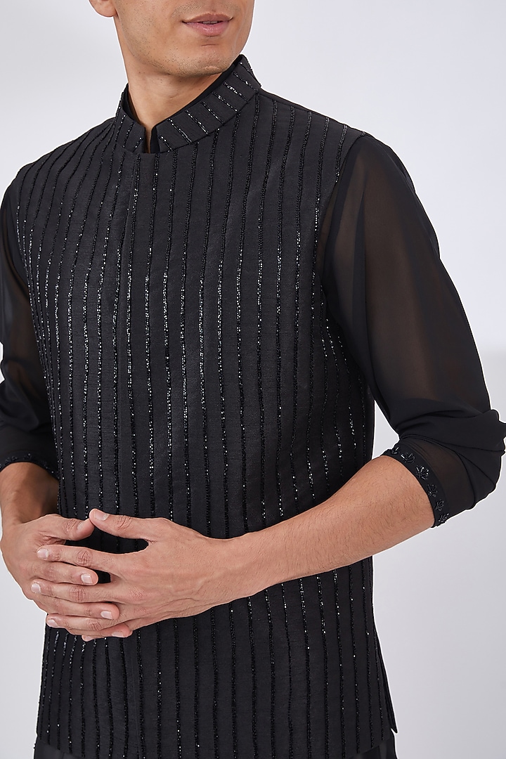 Black Raw Silk Embroidered Bundi Jacket Set by Dev Kumar at Pernia's Pop Up Shop
