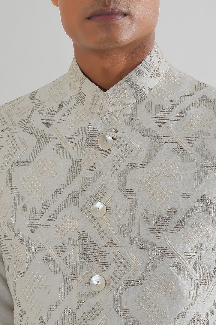 Ivory Silk Criss-Cross Embroidered Nehru Jacket by Dhruv Vaish at Pernia's Pop Up Shop