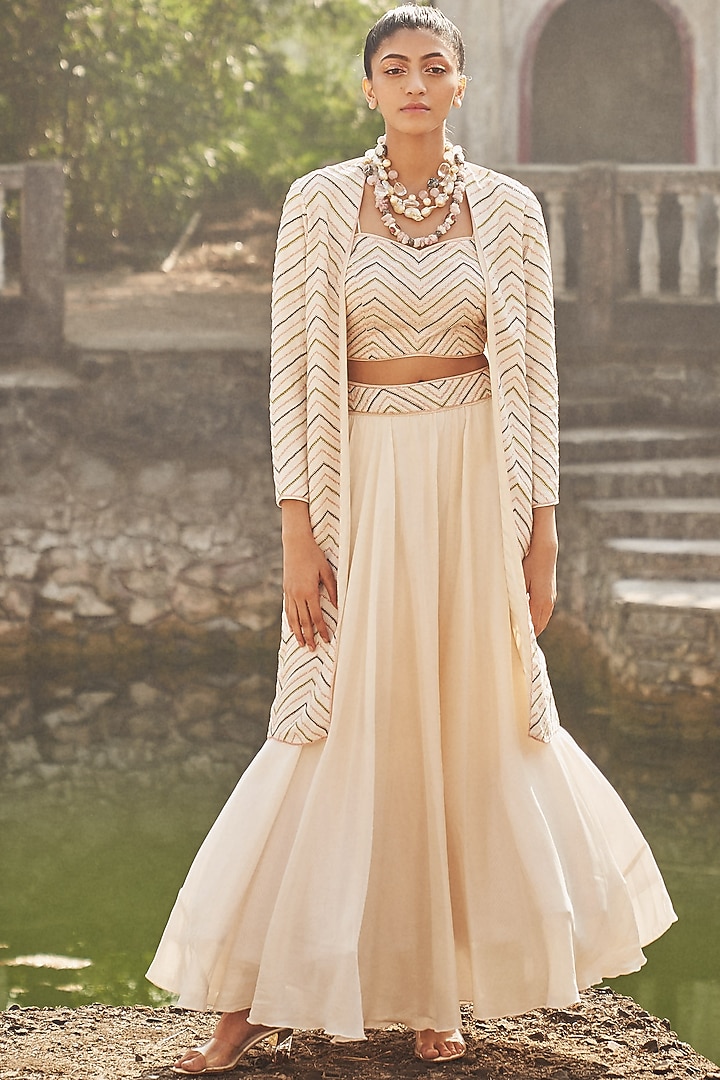 Ivory Embroidered Lehenga Set With Jacket by DISHA MUCHHALA at Pernia's Pop Up Shop