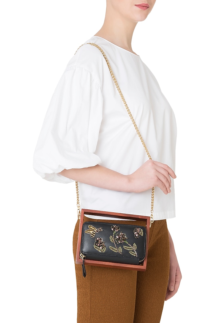 Black wood and leather embroidered clutch available only at Pernia's Pop Up Shop.