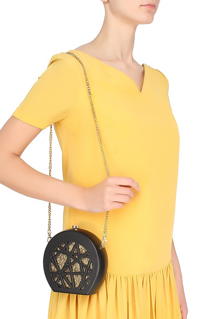 Duet luxury presents Black round box clutch with gold sequins insert available only at Pernia's Pop Up Shop.