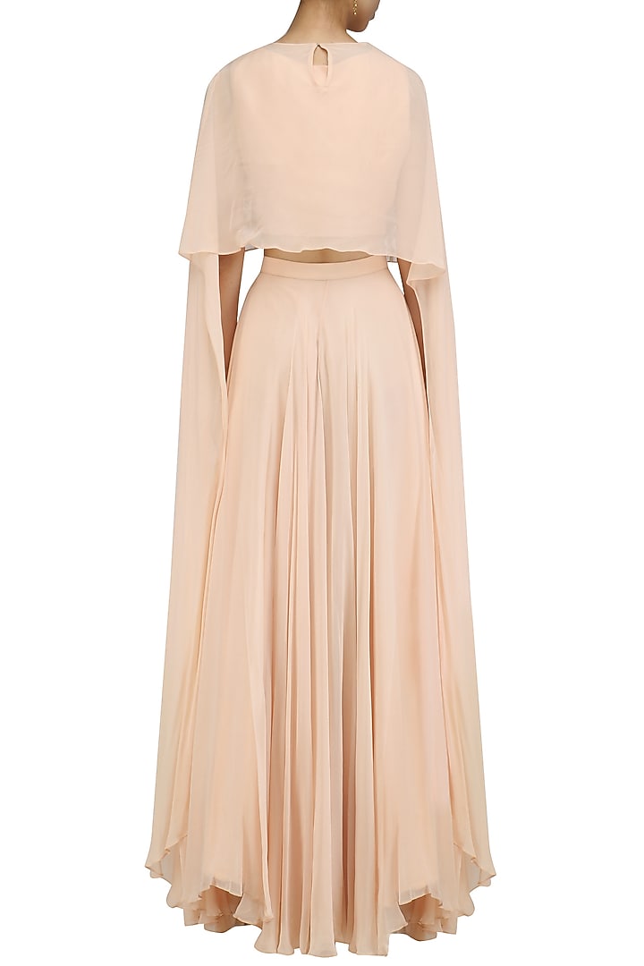 Peach long sleeves cape and lehenga skirt set available only at Pernia's Pop Up Shop.