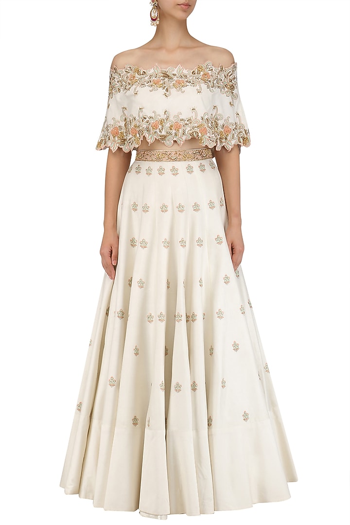Ivory off shoulder cape with lehenga set available only at Pernia's Pop Up Shop.