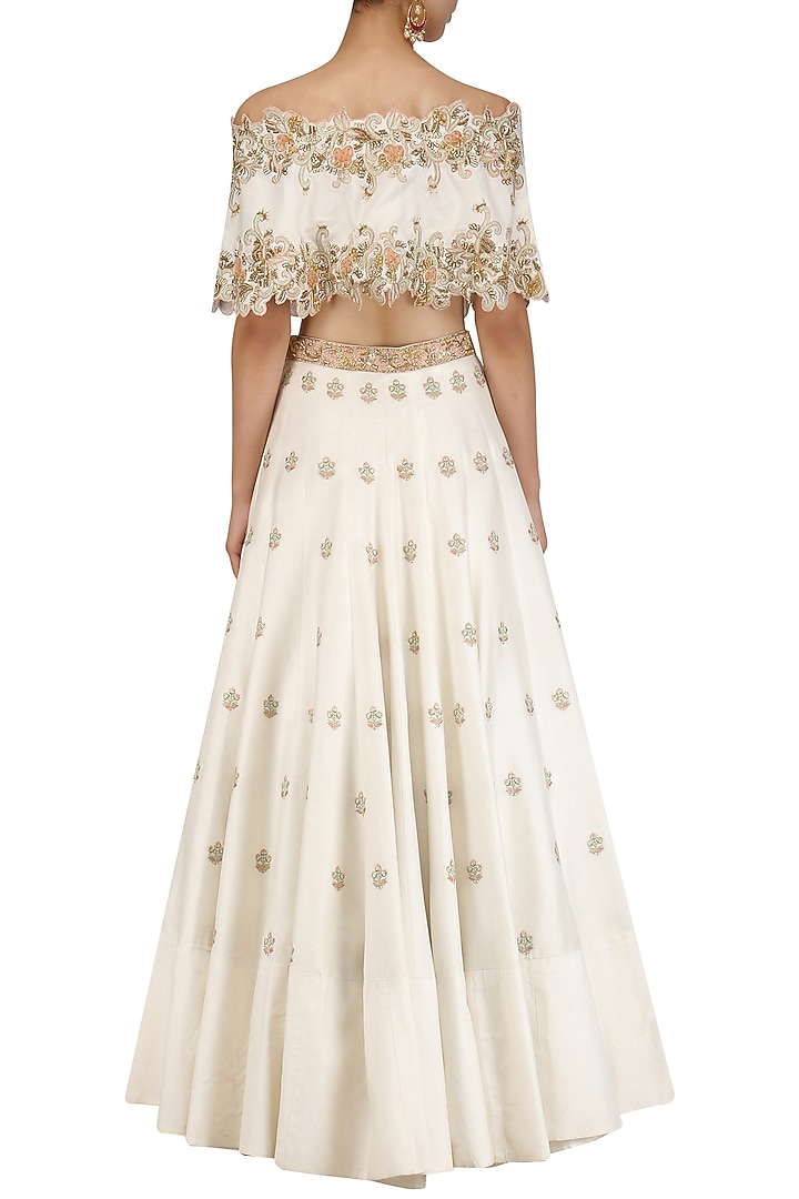 Ivory off shoulder cape with lehenga set available only at Pernia's Pop Up Shop.