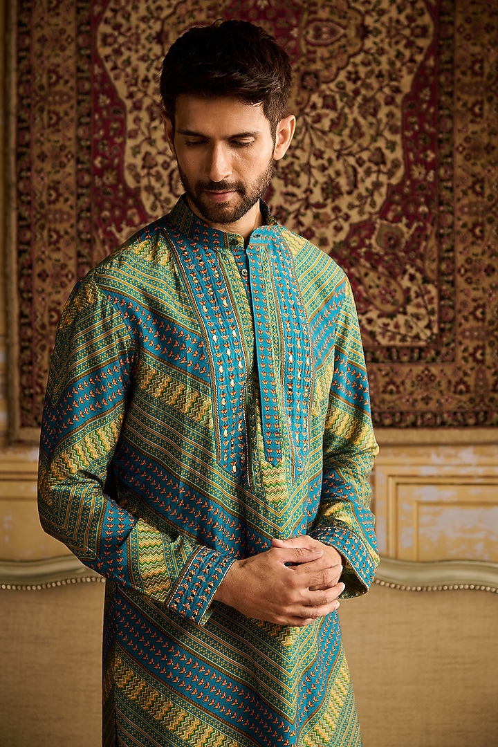 Teal Dola Silk Chevron Printed & Mirror Embellished Bundi Jacket Set by DiyaRajvvir Men at Pernia's Pop Up Shop