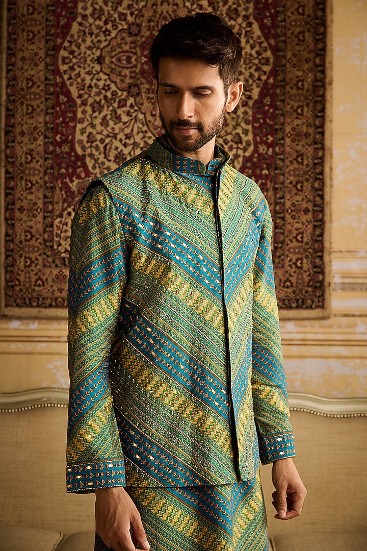 Teal Dola Silk Chevron Printed & Mirror Embellished Bundi Jacket Set by DiyaRajvvir Men at Pernia's Pop Up Shop