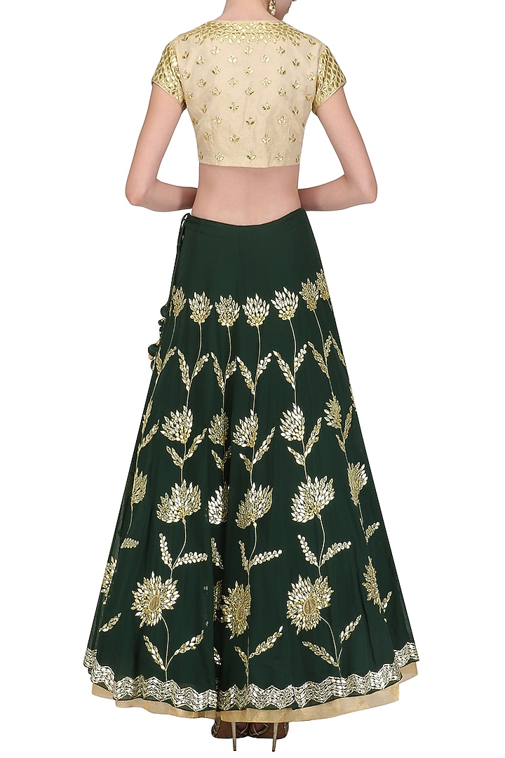 Emerald green and gold embroidered lehenga set available only at Pernia's Pop Up Shop.