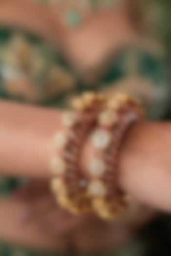 Gold Finish Kundan Polki & Red Stone Bangles (Set Of 2) by EKATHVA JAIPUR at Pernia's Pop Up Shop