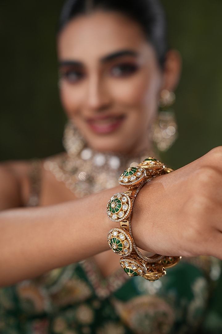 Gold Finish Kundan Polki & Green Stone Bangles (Set Of 2) by EKATHVA JAIPUR at Pernia's Pop Up Shop