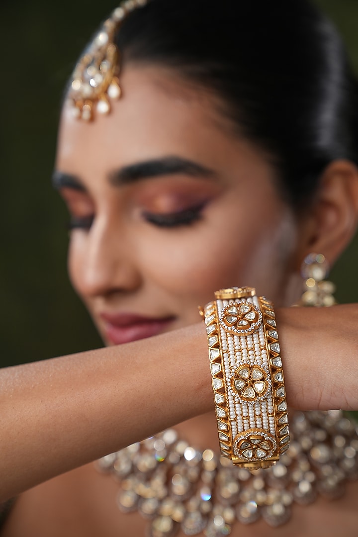 Gold Finish Kundan Polki Bangles (Set Of 2) by EKATHVA JAIPUR at Pernia's Pop Up Shop