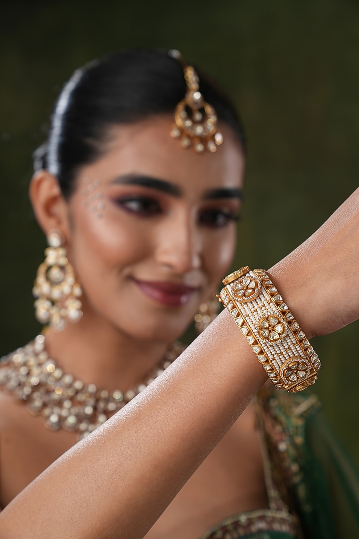 Gold Finish Kundan Polki Bangles (Set Of 2) by EKATHVA JAIPUR at Pernia's Pop Up Shop