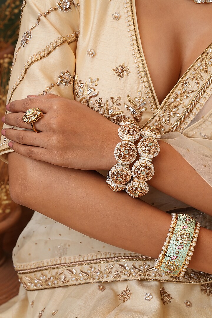 Gold Finish Kundan Polki Bangles (Set Of 2) by EKATHVA JAIPUR at Pernia's Pop Up Shop