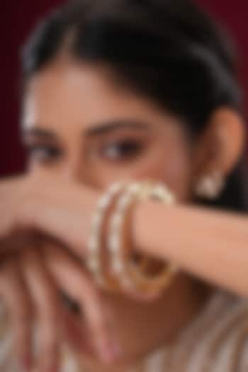 Gold Finish Kundan Polki Bangles (Set Of 2) by EKATHVA JAIPUR at Pernia's Pop Up Shop