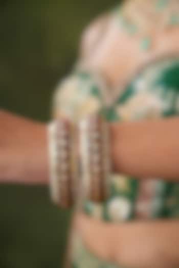 Gold Finish Kundan Polki & Red Stone Bangles (Set Of 2) by EKATHVA JAIPUR at Pernia's Pop Up Shop